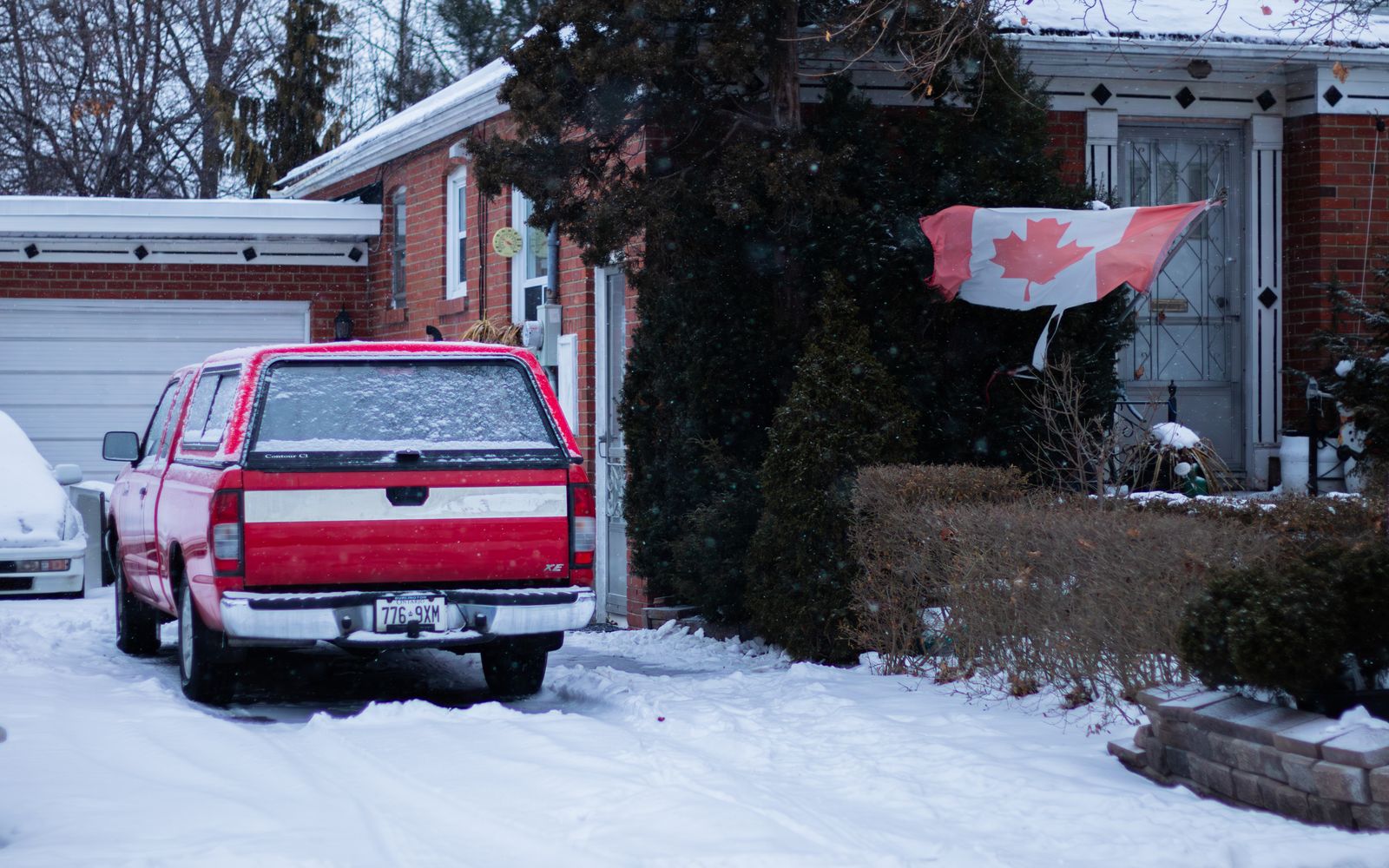 Canadian home with snow-covered front yard